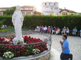 Praying before Our Lady statue