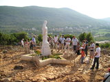 Praying before the statue of Our Lady statue at Podbrdo