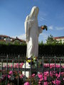Flowers put at the foot of Statue of Queen of Peace