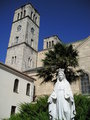 Statue of Our Lady at the monastery garden and the Church